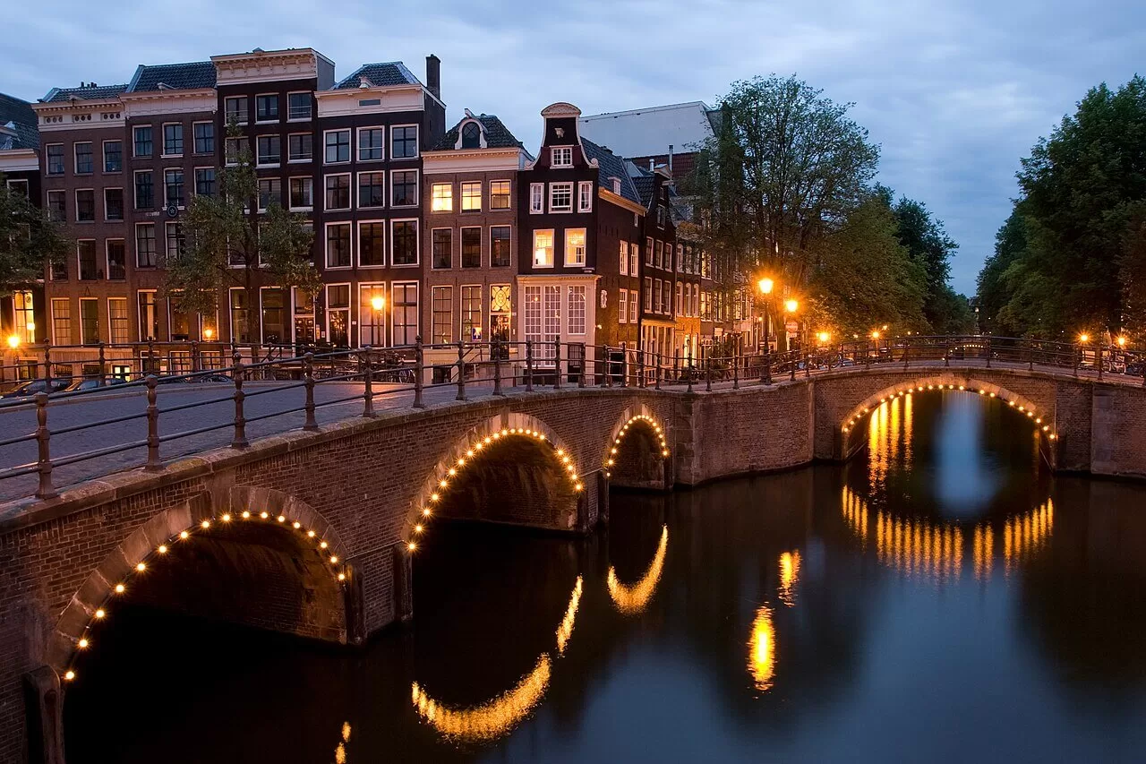 A view of the Reguliersgracht on the corner with the Keizersgracht, in Amsterdam, the Netherlands, at dusk.
